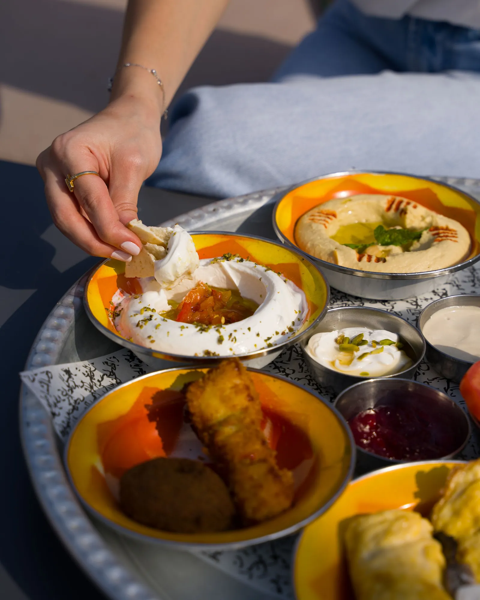 A mezze bowl of hummus with olive oil